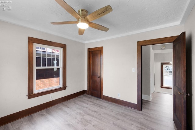1507 S Lakeview Blvd, Lorain, OH 44052 - unfurnished bedroom with a textured ceiling, light wood-type flooring, a ceiling fan, and baseboards