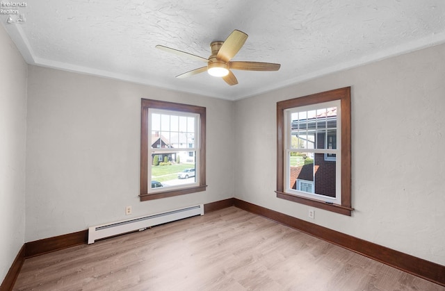 1507 S Lakeview Blvd, Lorain, OH 44052 - spare room featuring a baseboard heating unit, light wood finished floors, and a wealth of natural light