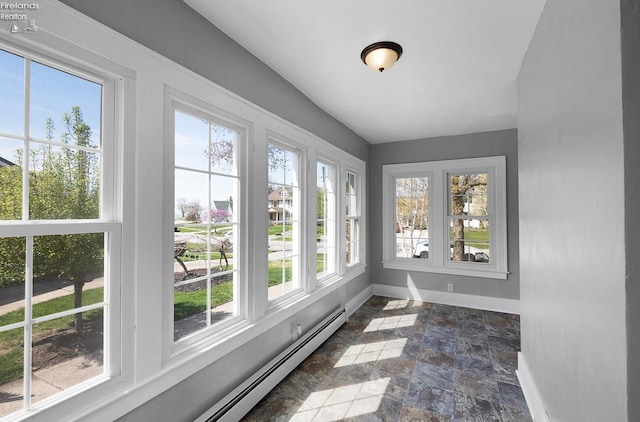 1507 S Lakeview Blvd, Lorain, OH 44052 - unfurnished sunroom with baseboards, baseboard heating, a wealth of natural light, and stone finish floor