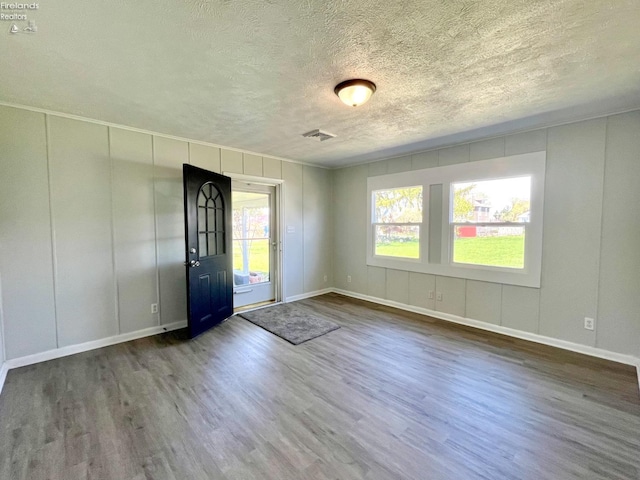 120 Mckim St, Bellevue, OH 44811 - entryway featuring a textured ceiling, visible vents, wood finished floors, and baseboards