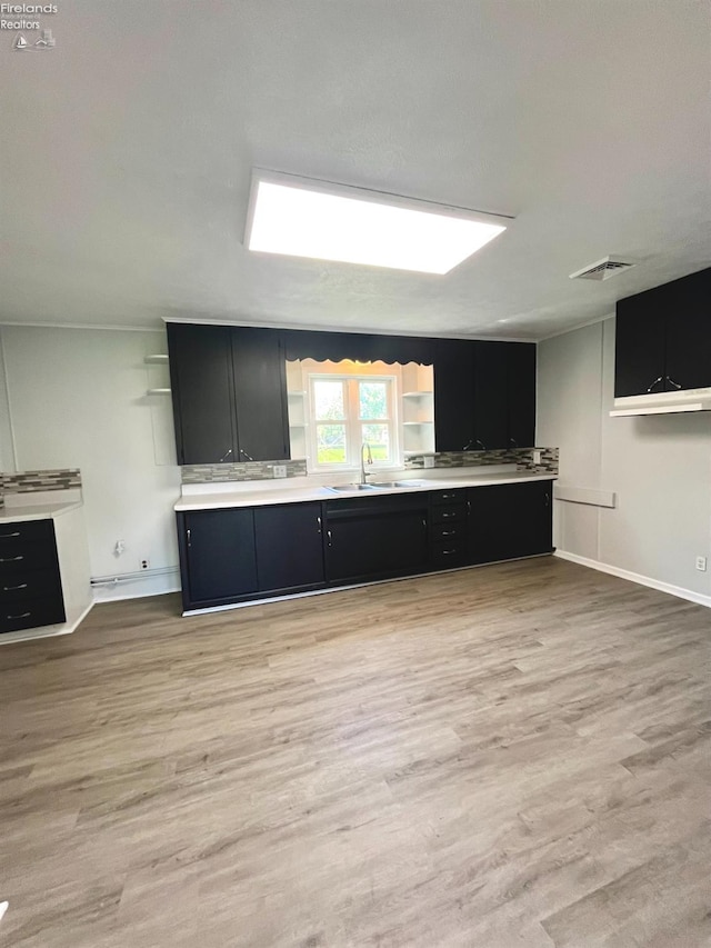 120 Mckim St, Bellevue, OH 44811 - kitchen with visible vents, dark cabinets, open shelves, a sink, and light wood-type flooring