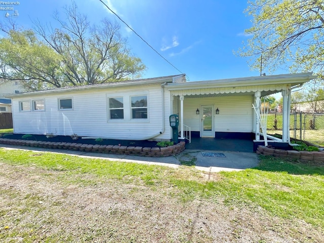 120 Mckim St, Bellevue, OH 44811 - rear view of property featuring fence, a carport, and a yard