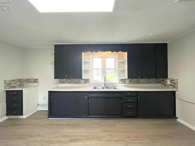 120 Mckim St, Bellevue, OH 44811 - kitchen featuring a sink, open shelves, decorative backsplash, and light wood-style floors