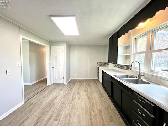 120 Mckim St, Bellevue, OH 44811 - kitchen featuring light wood finished floors, a sink, open shelves, and dark cabinets