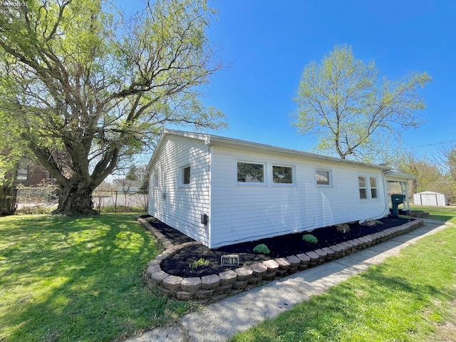 120 Mckim St, Bellevue, OH 44811 - view of property exterior with an outdoor structure, a lawn, and a storage unit