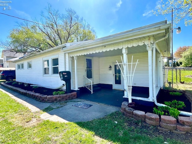120 Mckim St, Bellevue, OH 44811 - view of front of house with fence, driveway, and an attached carport