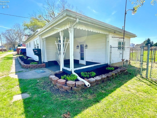 120 Mckim St, Bellevue, OH 44811 - view of property exterior with a porch, a lawn, and fence