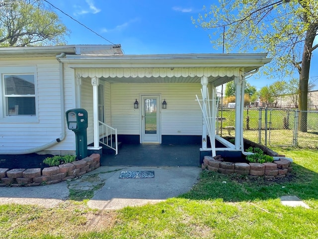 120 Mckim St, Bellevue, OH 44811 - view of exterior entry featuring fence, a carport, and a lawn
