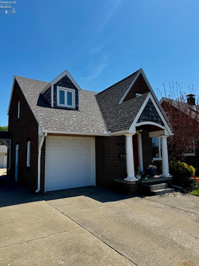 5106 Ottawa River Rd, Toledo, OH 43611 - view of front of house featuring concrete driveway, roof with shingles, and brick siding