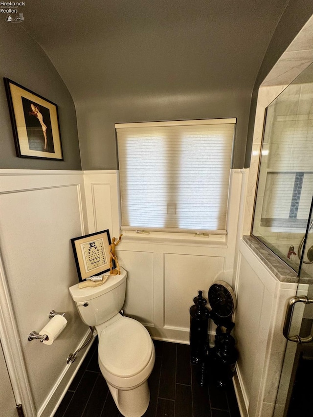 5106 Ottawa River Rd, Toledo, OH 43611 - full bath featuring a shower stall, wood tiled floor, toilet, a decorative wall, and wainscoting