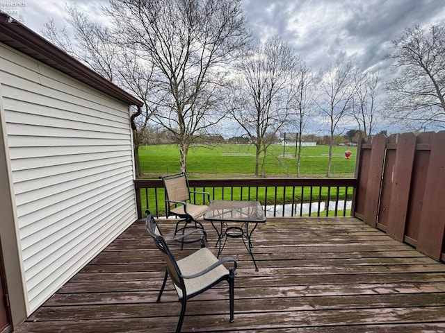wooden deck with a lawn