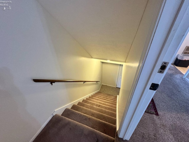 stairs with baseboards and carpet floors