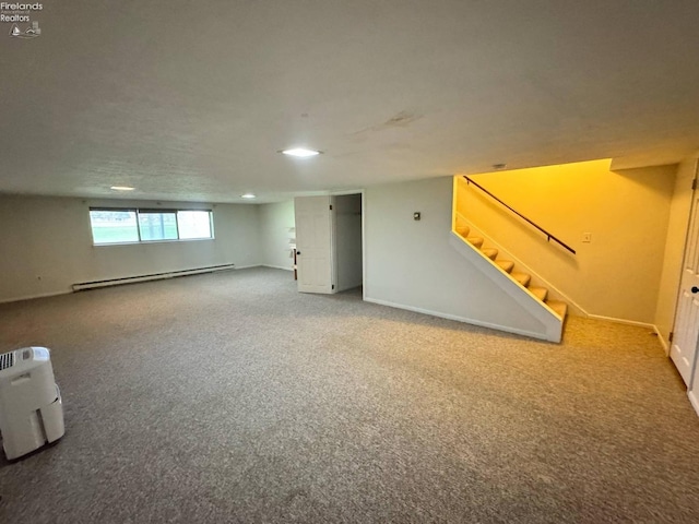 basement featuring recessed lighting, baseboard heating, carpet flooring, baseboards, and stairway
