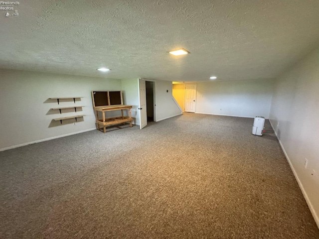finished below grade area featuring baseboards, recessed lighting, carpet floors, and a textured ceiling