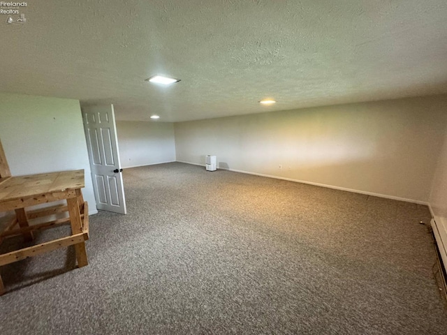 finished below grade area with recessed lighting, a textured ceiling, carpet floors, and baseboards