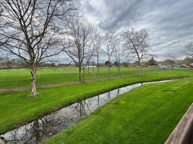 surrounding community with a yard and fence