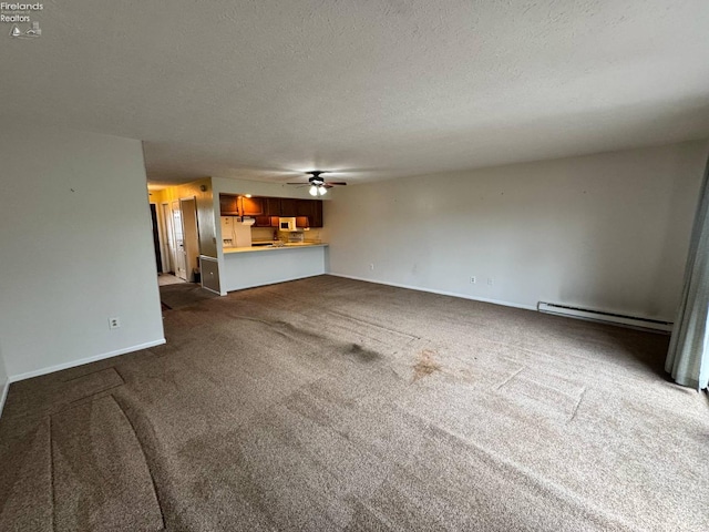 unfurnished living room with dark carpet, a textured ceiling, ceiling fan, and a baseboard heating unit