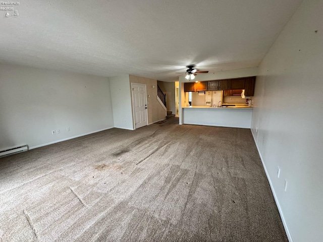 unfurnished living room featuring carpet flooring, ceiling fan, and baseboards