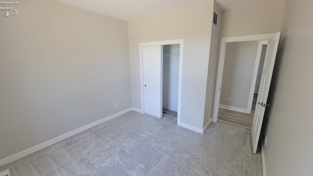 unfurnished bedroom with baseboards, visible vents, a closet, and carpet flooring