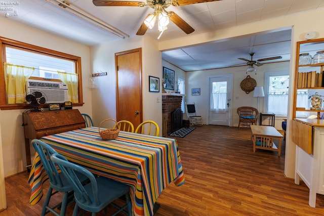 428 Cedar, Lakeside, OH 43440 - dining room featuring a ceiling fan, wood finished floors, healthy amount of natural light, and a fireplace