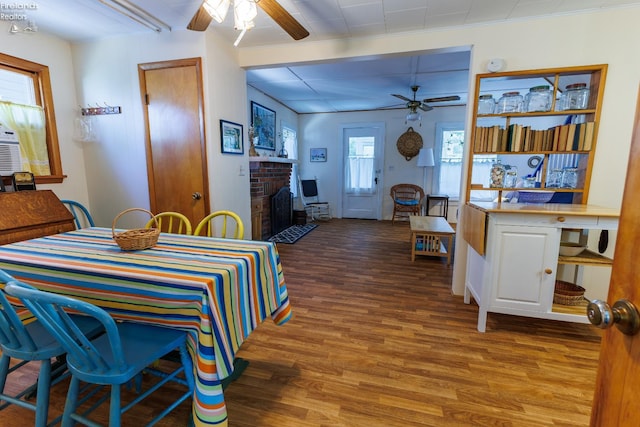 428 Cedar, Lakeside, OH 43440 - dining room featuring ceiling fan, wood finished floors, and a brick fireplace