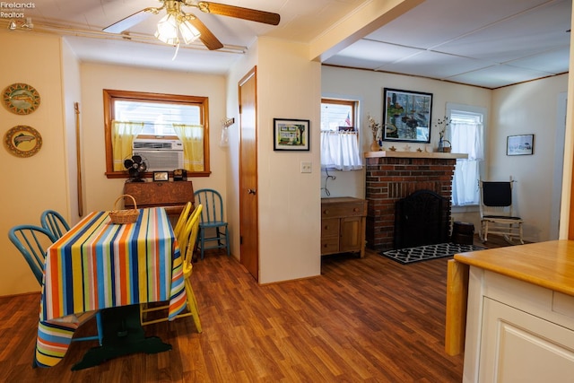 428 Cedar, Lakeside, OH 43440 - dining area with wood finished floors, a ceiling fan, cooling unit, ornamental molding, and a brick fireplace