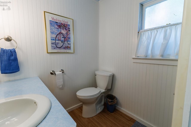 428 Cedar, Lakeside, OH 43440 - bathroom featuring wood finished floors, toilet, vanity, and baseboards