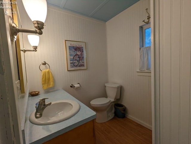 428 Cedar, Lakeside, OH 43440 - half bathroom with vanity, wood finished floors, and toilet