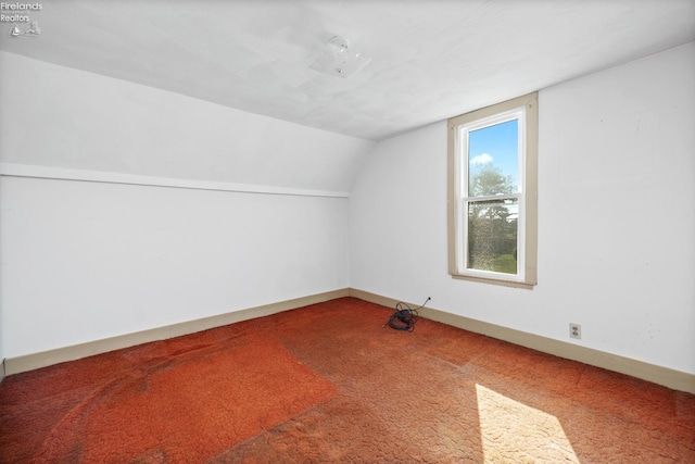 bonus room with carpet floors, baseboards, and lofted ceiling