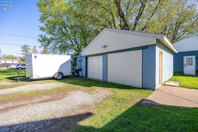 detached garage featuring driveway