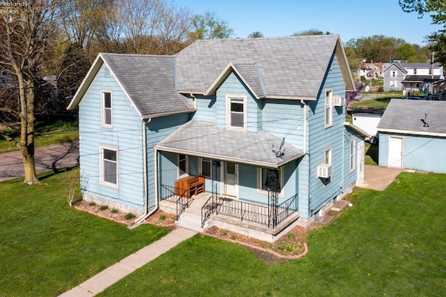 view of front of home with a porch, a shingled roof, and a front lawn