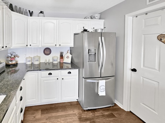173 Excalibur Dr, Clyde, OH 43410 - kitchen with stainless steel refrigerator with ice dispenser, white cabinetry, dark wood-type flooring, and dark stone counters
