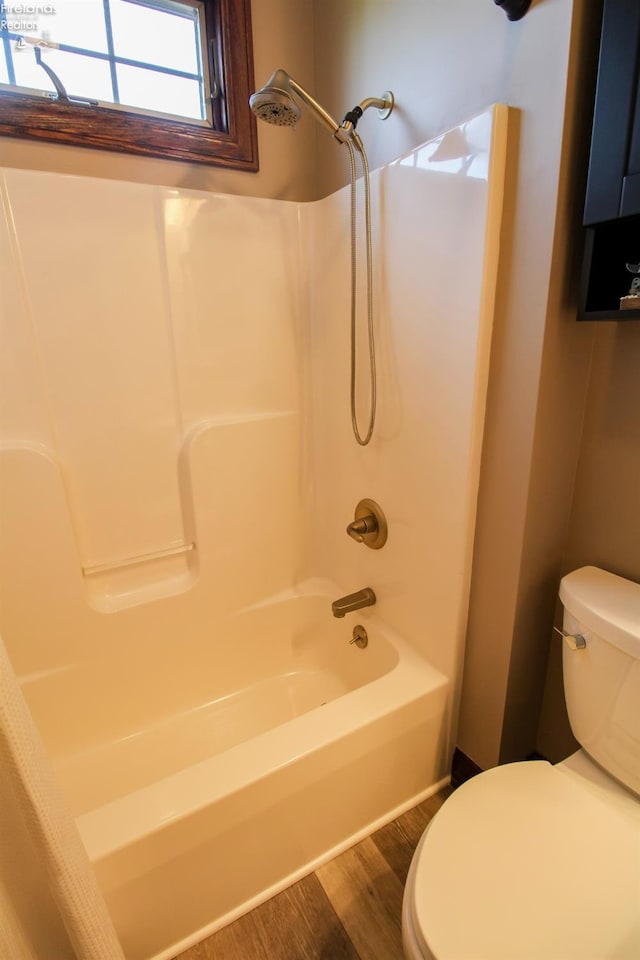 9117 W Mason Rd, Castalia, OH 44824 - bathroom featuring toilet, wood finished floors, and shower / bathtub combination