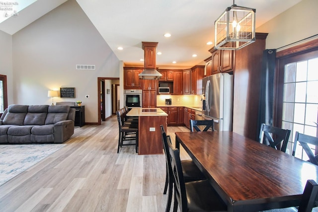 9117 W Mason Rd, Castalia, OH 44824 - dining room featuring high vaulted ceiling, light wood-style floors, recessed lighting, and baseboards
