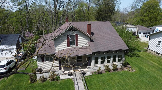 view of front of property with a front lawn and a chimney