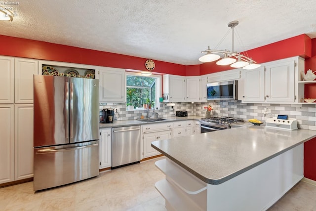 11595 Gore Orphanage Rd, Wakeman, OH 44889 - kitchen with appliances with stainless steel finishes, a sink, a peninsula, white cabinetry, and open shelves