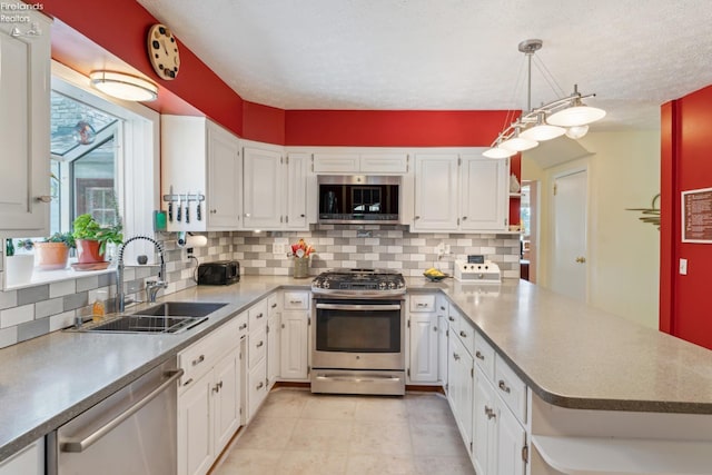 11595 Gore Orphanage Rd, Wakeman, OH 44889 - kitchen with appliances with stainless steel finishes, a sink, a peninsula, white cabinets, and backsplash