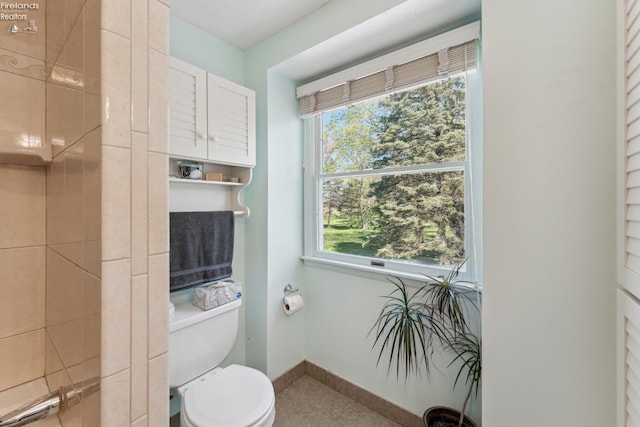 11595 Gore Orphanage Rd, Wakeman, OH 44889 - bathroom featuring toilet, tile patterned flooring, healthy amount of natural light, and baseboards