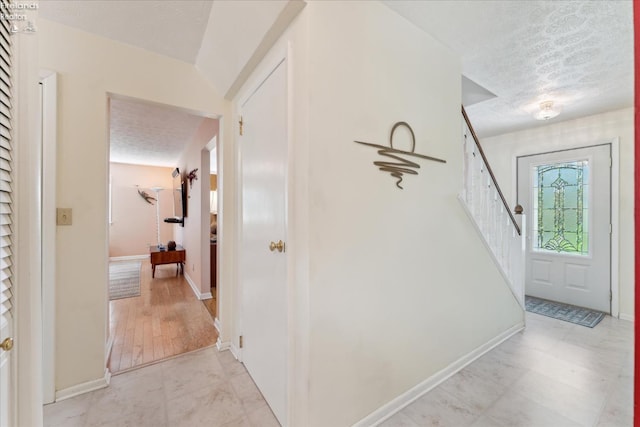 11595 Gore Orphanage Rd, Wakeman, OH 44889 - hallway with a textured ceiling, stairs, and baseboards