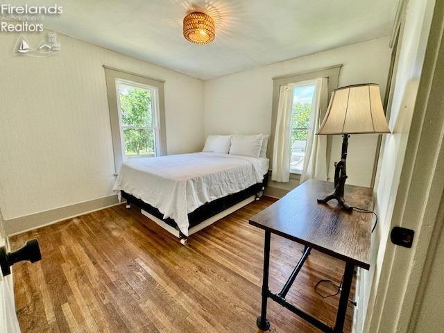 1026 Claremont Ave, Ashland, OH 44805 - bedroom featuring multiple windows, wood finished floors, and baseboards