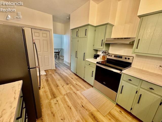 1026 Claremont Ave, Ashland, OH 44805 - kitchen with appliances with stainless steel finishes, under cabinet range hood, green cabinetry, light countertops, and light wood-type flooring