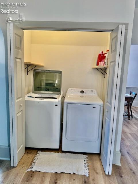 1026 Claremont Ave, Ashland, OH 44805 - washroom with washing machine and clothes dryer, light wood finished floors, and arched walkways