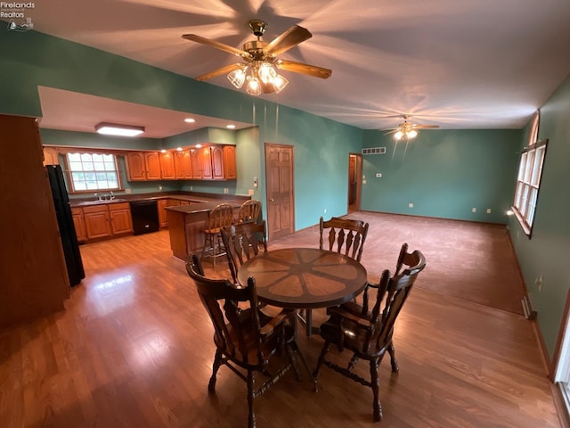 dining area with light wood-style floors, visible vents, baseboards, and a ceiling fan