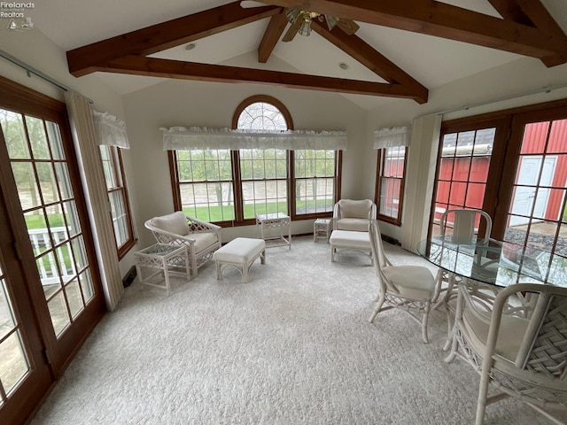 sunroom featuring beam ceiling and french doors