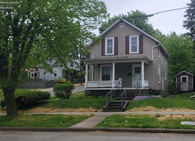 view of front facade featuring a porch, an outdoor structure, and stairway