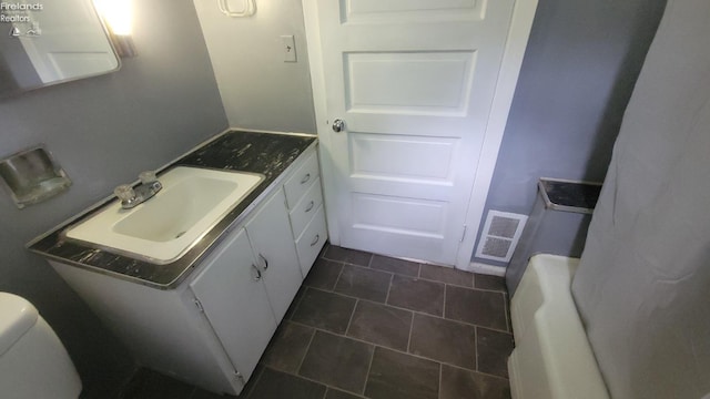 bathroom with visible vents, toilet, and vanity