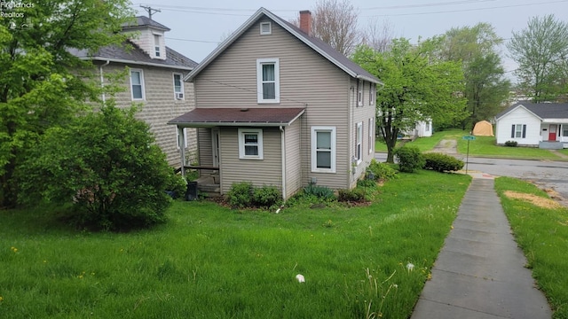 view of home's exterior featuring a lawn and a chimney