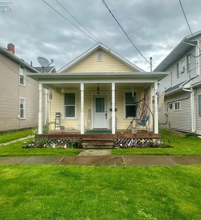 view of front facade with covered porch and a front yard
