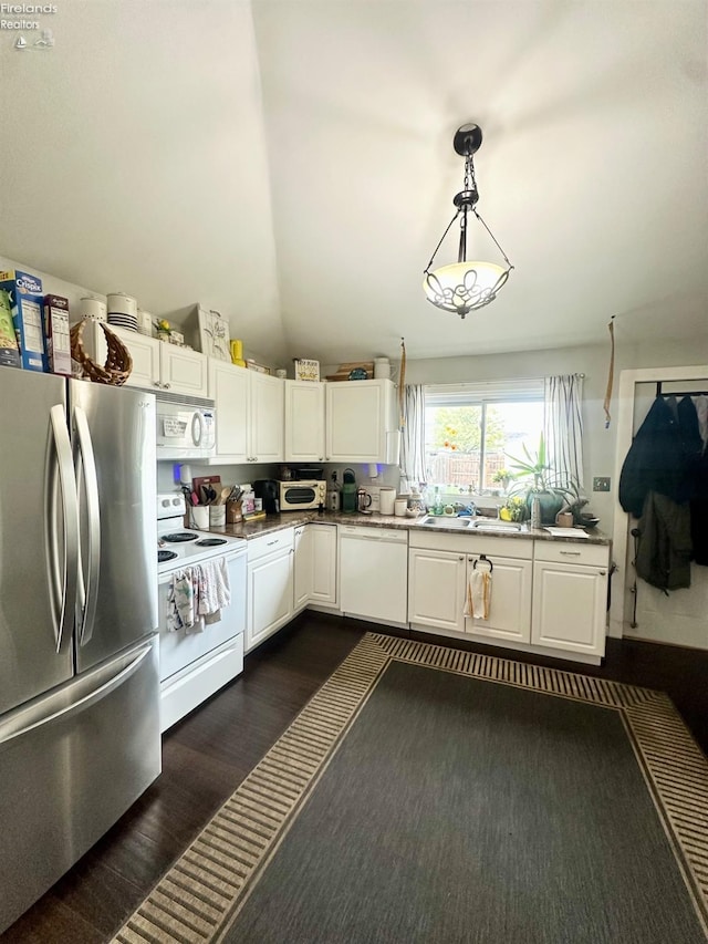 kitchen with white appliances, white cabinetry, pendant lighting, and dark wood-style floors