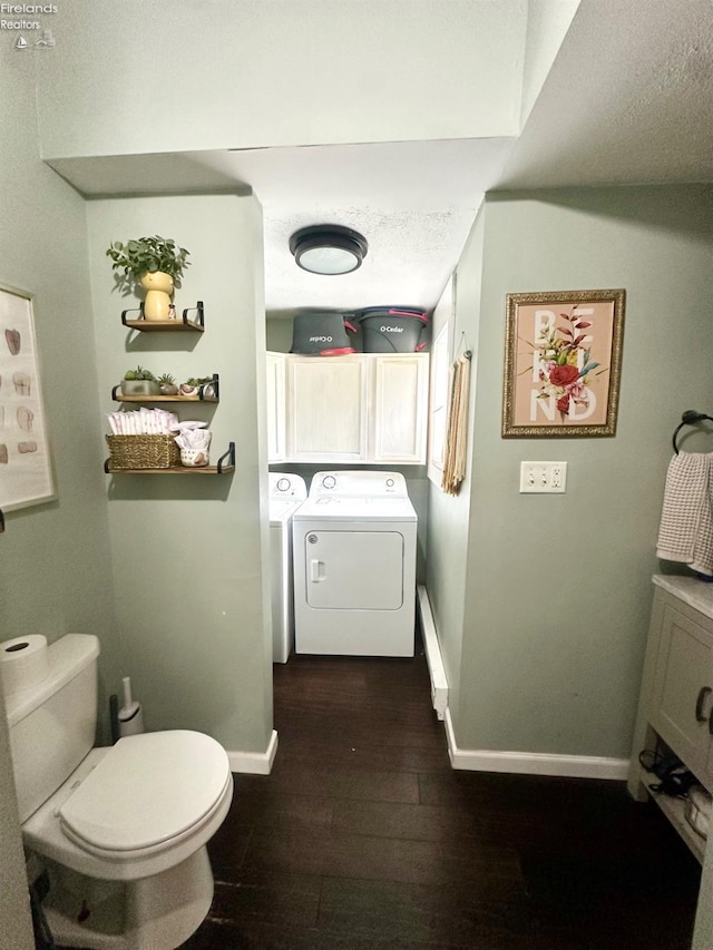 bathroom featuring independent washer and dryer, wood-type flooring, toilet, a textured ceiling, and baseboards